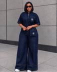 Luxe Indigo Denim Jumpsuit With cross bag.